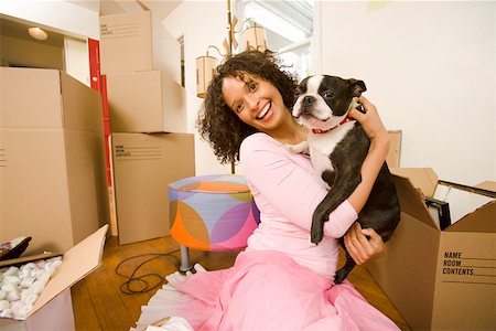 Woman holding dog in new home Stock Photo - Premium Royalty-Free, Code: 673-02139897