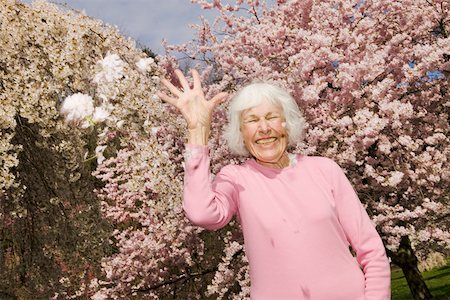 Happy woman throwing flowers Stock Photo - Premium Royalty-Free, Code: 673-02140034