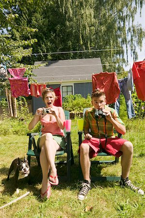 Surprised couple with camera and binoculars Stock Photo - Premium Royalty-Free, Code: 673-02140052