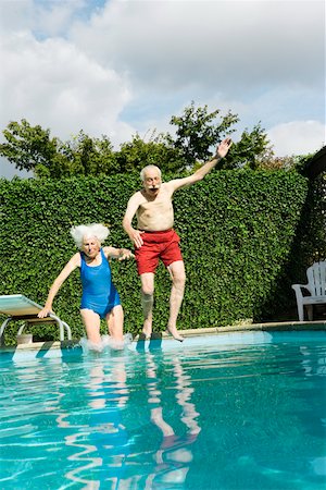 senior woman pool - Senior couple jumping into pool Stock Photo - Premium Royalty-Free, Code: 673-02140202