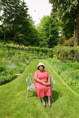 Portrait of woman sitting in park Stock Photo - Premium Royalty-Free, Code: 673-02140259