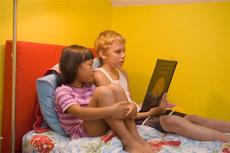 Brother reading to his little sister Stock Photo - Premium Royalty-Free, Code: 673-02140276