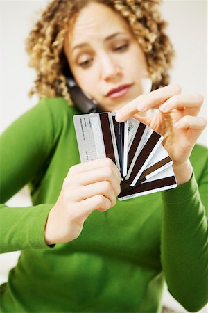 debit - Woman on phone choosing credit card Stock Photo - Premium Royalty-Free, Code: 673-02140333