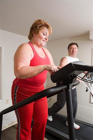 programming - Overweight couple using exercise machines Stock Photo - Premium Royalty-Free, Code: 673-02140417