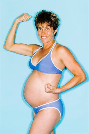 female flexing biceps - Pregnant woman in bikini showing muscles Stock Photo - Premium Royalty-Free, Code: 673-02140435
