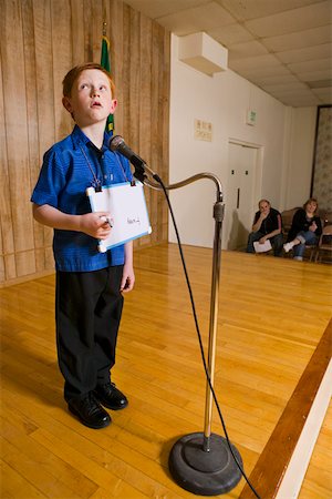 spell - Young boy on stage with microphone Stock Photo - Premium Royalty-Free, Code: 673-02140495