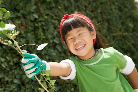 Smiling girl wearing gardening gloves Stock Photo - Premium Royalty-Free, Code: 673-02140516