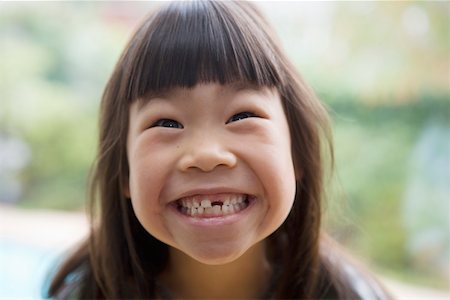 Grinning girl with missing tooth Stock Photo - Premium Royalty-Free, Code: 673-02140521