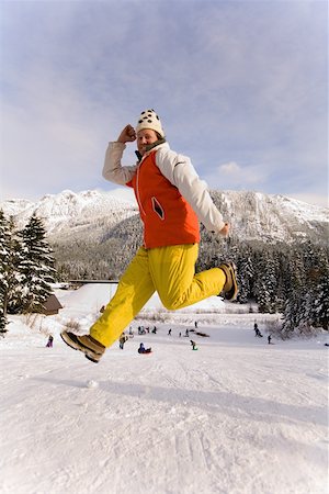 Portrait of man jumping in snow Stock Photo - Premium Royalty-Free, Code: 673-02141122