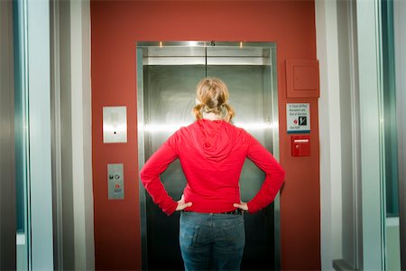 facing away - Rear view of teenage girl waiting for elevator Stock Photo - Premium Royalty-Free, Code: 673-02141139