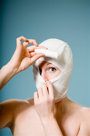 Woman with head wrapped in bandage Stock Photo - Premium Royalty-Free, Code: 673-02141156