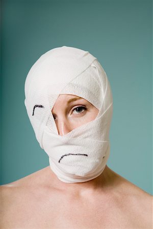 Woman with head wrapped in bandage Stock Photo - Premium Royalty-Free, Code: 673-02141162