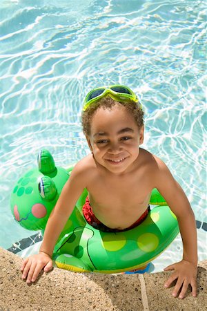 Young boy wearing a flotation device in pool Stock Photo - Premium Royalty-Free, Code: 673-02141557