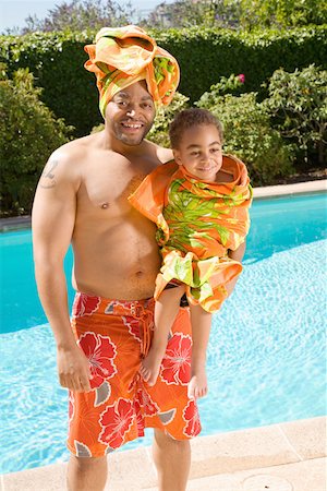 Father and son drying off by pool Stock Photo - Premium Royalty-Free, Code: 673-02141563