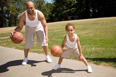 Father and son dribbling basketballs Stock Photo - Premium Royalty-Free, Code: 673-02141580