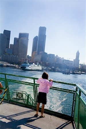 facing away - Young girl standing on dock overlooking city bay Stock Photo - Premium Royalty-Free, Code: 673-02141630