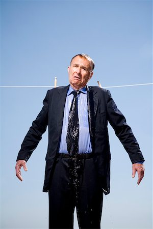 saturating - Businessman hung out to dry Stock Photo - Premium Royalty-Free, Code: 673-02141779