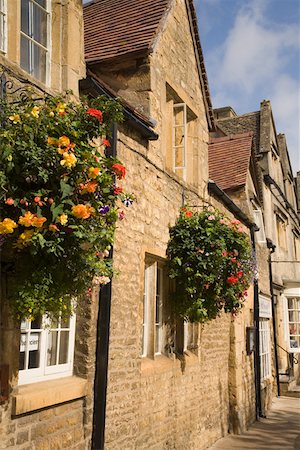 flower box - Hanging flower boxes on stone buildings, Cotswolds, United Kingdom Stock Photo - Premium Royalty-Free, Code: 673-02141855