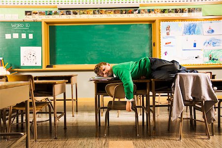 sleeper - Boy sleeping on desks in classroom Stock Photo - Premium Royalty-Free, Code: 673-02141873