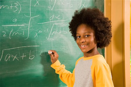 Portrait of boy writing on blackboard Stock Photo - Premium Royalty-Free, Code: 673-02141882