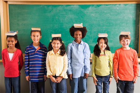 school head girl - Row of students with books on their heads in classroom Stock Photo - Premium Royalty-Free, Code: 673-02141922