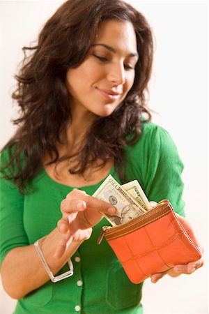 remunerating - Woman taking money out of wallet Stock Photo - Premium Royalty-Free, Code: 673-02141988