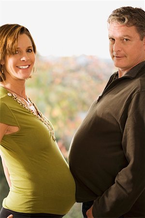 Portrait of pregnant couple touching bellies Foto de stock - Sin royalties Premium, Código: 673-02142078