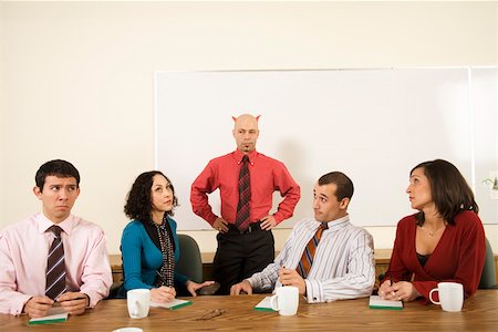 Angry businesspeople next to boss with horns over head Stock Photo - Premium Royalty-Free, Code: 673-02142260