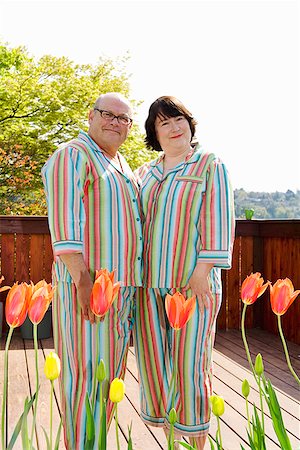 Couple standing on patio in matching pajamas Stock Photo - Premium Royalty-Free, Code: 673-02142458