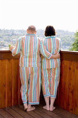 Couple standing on patio in matching pajamas Stock Photo - Premium Royalty-Free, Code: 673-02142452