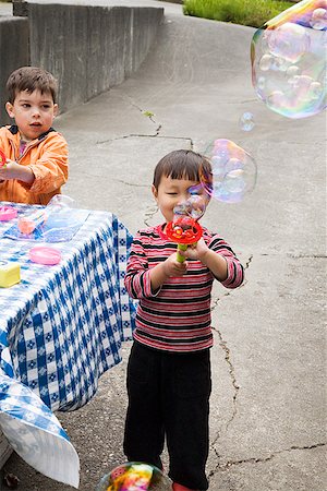 Young boy blowing bubbles Stock Photo - Premium Royalty-Free, Code: 673-02142695