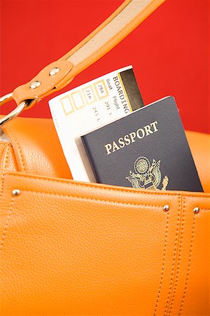 Passport sticking out of orange purse Stock Photo - Premium Royalty-Free, Code: 673-02142767