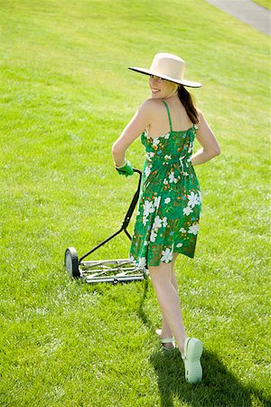 elevated view of lawnmower - Woman pushing lawn mower Stock Photo - Premium Royalty-Free, Code: 673-02142829