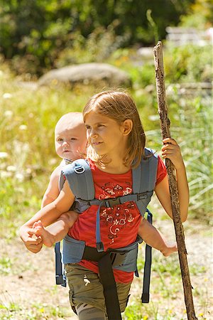 Girl carrying baby sibling on back Stock Photo - Premium Royalty-Free, Code: 673-02142914