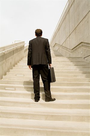 facing away - Businessman looking up steps Stock Photo - Premium Royalty-Free, Code: 673-02142974
