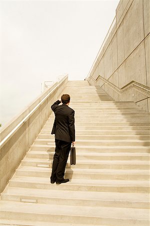 raised - Businessman looking up steps Stock Photo - Premium Royalty-Free, Code: 673-02142976