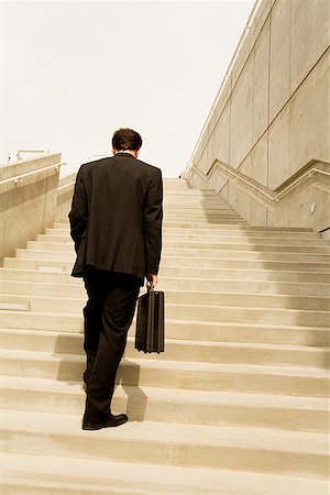 facing away - Businessman walking up steps Stock Photo - Premium Royalty-Free, Code: 673-02142973