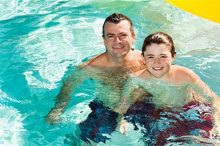 saturating - Father and son in swimming pool Stock Photo - Premium Royalty-Free, Code: 673-02143076