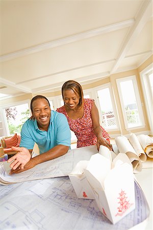 African couple looking at blueprints Stock Photo - Premium Royalty-Free, Code: 673-02143161