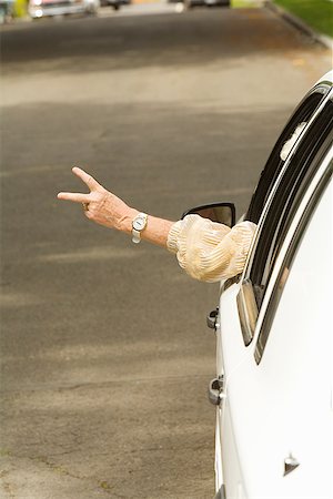 elderly sign - Senior woman’s arm sticking out of car Stock Photo - Premium Royalty-Free, Code: 673-02143222