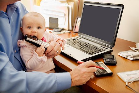 daughter sitting on dad lap - Businessman working with baby on lap Stock Photo - Premium Royalty-Free, Code: 673-02143262