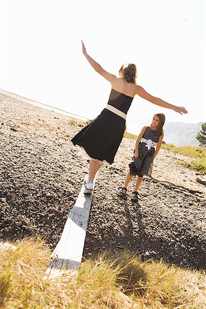 facing away - Sisters in party dresses outdoors Stock Photo - Premium Royalty-Free, Code: 673-02143294