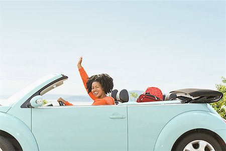 packed - African woman driving convertible car Stock Photo - Premium Royalty-Free, Code: 673-02143406