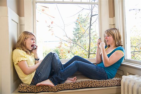 Teenaged sisters talking on cell phones Stock Photo - Premium Royalty-Free, Code: 673-02143578