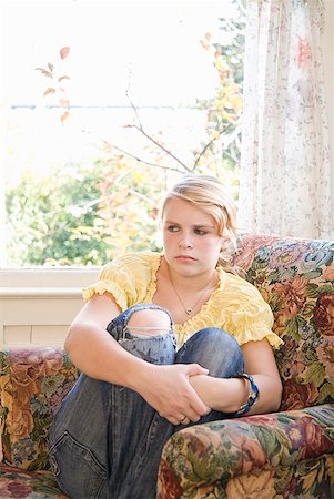 Angry teenaged girl sitting in chair Stock Photo - Premium Royalty-Free, Code: 673-02143572