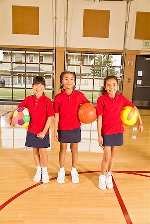 Multi-ethnic girls holding sports balls Stock Photo - Premium Royalty-Free, Code: 673-02143704
