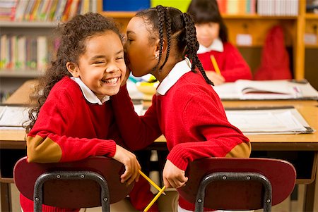 pictures of a little girl whispering - African girls telling secret in classroom Stock Photo - Premium Royalty-Free, Code: 673-02143703