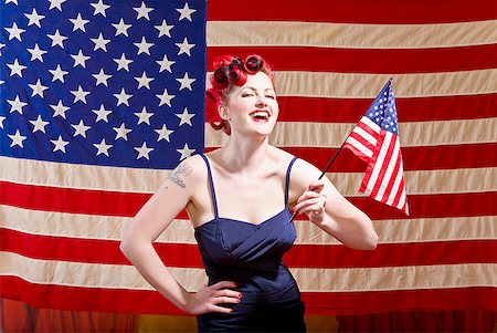 Woman holding American flag Stock Photo - Premium Royalty-Free, Code: 673-02143770