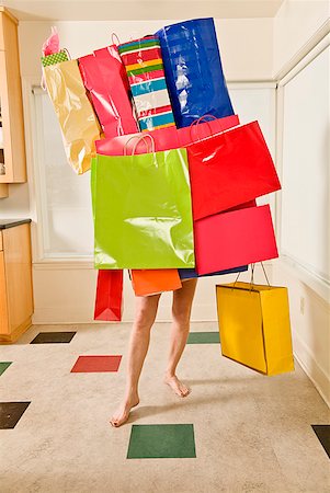 paid - Woman balancing assorted shopping bags Stock Photo - Premium Royalty-Free, Code: 673-02216262