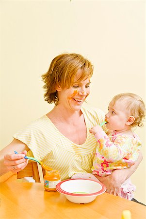 eating happy people 50 - Mother feeding messy baby Stock Photo - Premium Royalty-Free, Code: 673-02216301